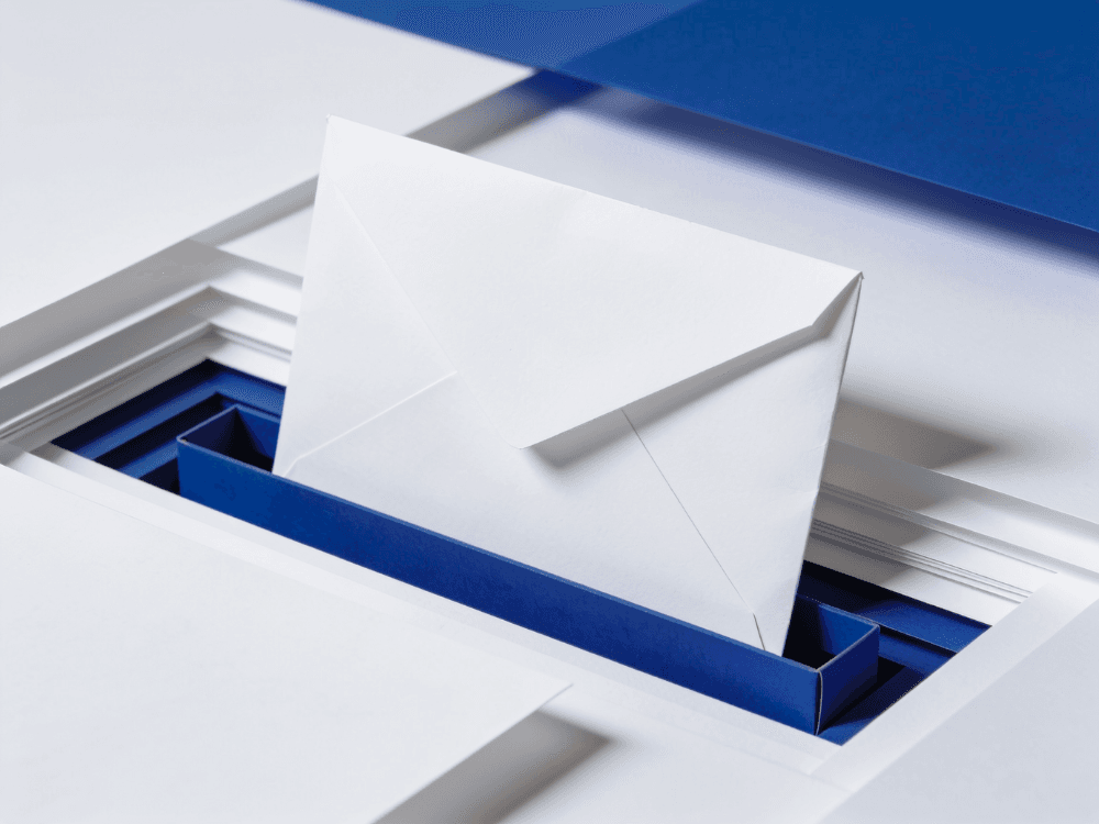 Papercraft envelope standing in a blue submission slot