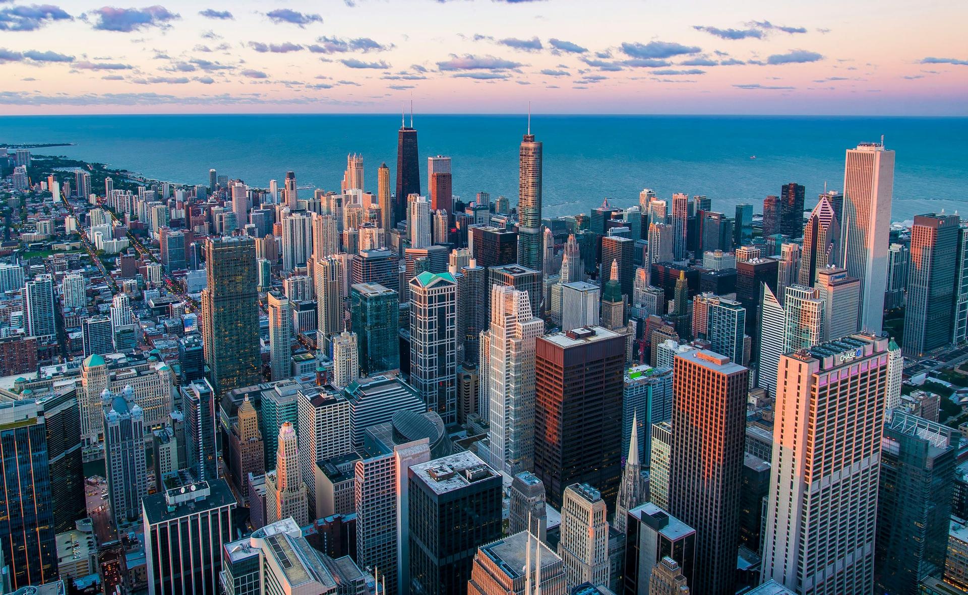 Aerial view of the Chicago skyline beside Lake Michigan at dusk